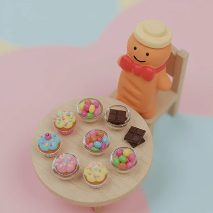 ginger man shaped toy sitting at a table